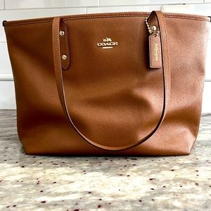 Tan/Camel Coach tote. Fits notebooks, small electronics, small laptop.